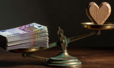 Balanza con dinero y corazón a cada lado